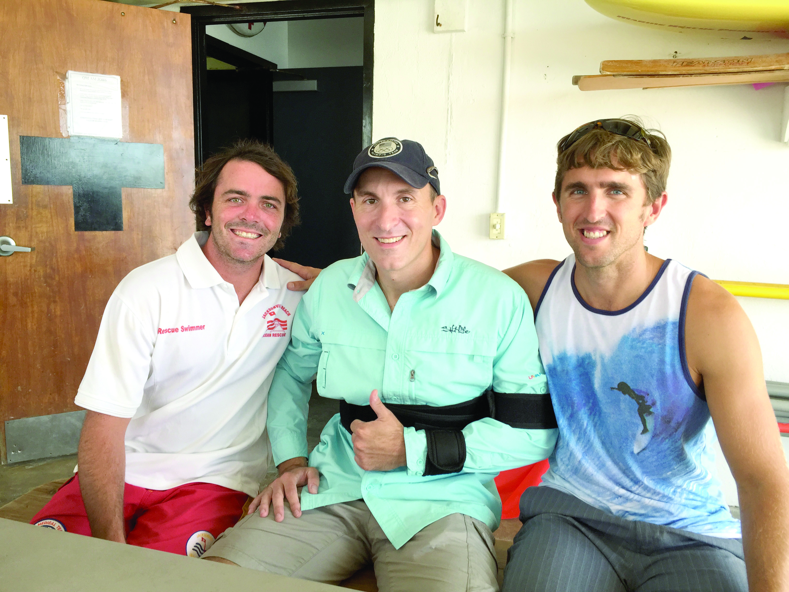 J.R. Bourne (center) flanked by two of his lifeguard
            rescuers, Gordy Van Dusen (left) and Ross Ghiotto (right).